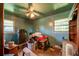 Bedroom featuring two windows, ceiling fan and blue paint at 379 Utoy Sw Cir, Atlanta, GA 30331