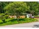 Inviting single-story brick home on a green lawn with mature trees, exuding warmth and character at 379 Utoy Sw Cir, Atlanta, GA 30331