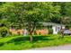 Charming single-story brick home featuring a lush, green lawn and mature trees for added privacy and curb appeal at 379 Utoy Sw Cir, Atlanta, GA 30331
