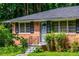 Close up shot of a brick house entrance with black trim and a metal security door adding charm and security at 379 Utoy Sw Cir, Atlanta, GA 30331