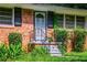 Detailed view of a home's entrance with a black security door and brick facade, showing classic design elements at 379 Utoy Sw Cir, Atlanta, GA 30331