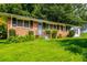 Traditional brick home with green lawn and garden beds offers a serene setting and classic charm at 379 Utoy Sw Cir, Atlanta, GA 30331