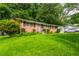 Classic brick home with a well-manicured lawn and detailed shutters for a welcoming facade at 379 Utoy Sw Cir, Atlanta, GA 30331