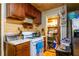 Compact kitchen featuring wooden cabinets, a gas range, and a walk-in pantry at 379 Utoy Sw Cir, Atlanta, GA 30331