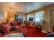 A living room has patterned sofas, a TV, and unique decor in an older-style home at 379 Utoy Sw Cir, Atlanta, GA 30331