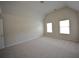 This bedroom features vaulted ceilings, carpet and neutral walls at 7753 Hansel Ln, Lithonia, GA 30058