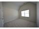 This bedroom features vaulted ceilings, carpet, and a window at 7753 Hansel Ln, Lithonia, GA 30058