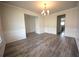 Dining room with hardwood floors, modern chandelier, and neutral colors at 7753 Hansel Ln, Lithonia, GA 30058