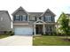 Charming two-story home with a well-manicured lawn and a two-car garage at 7753 Hansel Ln, Lithonia, GA 30058