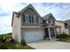 Side view of a charming two-story home with a well-manicured lawn at 7753 Hansel Ln, Lithonia, GA 30058
