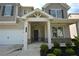 Charming front porch with white columns and well-manicured landscaping at 7753 Hansel Ln, Lithonia, GA 30058