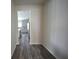 Hallway with wood-look floors that lead to the kitchen and dining area at 7753 Hansel Ln, Lithonia, GA 30058