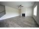 Inviting living room featuring a fireplace, ceiling fan, and wood-look flooring at 7753 Hansel Ln, Lithonia, GA 30058
