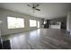 Open-concept living area showcasing wood-look floors and seamless transition into the kitchen at 7753 Hansel Ln, Lithonia, GA 30058