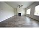 Spacious living room with wood-look floors, fireplace, and multiple windows for natural light at 7753 Hansel Ln, Lithonia, GA 30058
