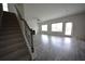 Bright living room featuring wood-look floors, fireplace, and staircase at 7753 Hansel Ln, Lithonia, GA 30058