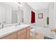 Well-lit bathroom with a tub, shower, and sink with wooden cabinets at 144 Wiley Dr, Douglasville, GA 30134