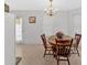 Cozy dining area featuring a wooden table, chandelier lighting, and view of doorway at 144 Wiley Dr, Douglasville, GA 30134