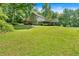 Home exterior showcases a sprawling lawn, carport, and ample parking space at 144 Wiley Dr, Douglasville, GA 30134