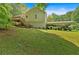 Home's backyard features a carport, back stairs, and a sprawling yard at 144 Wiley Dr, Douglasville, GA 30134