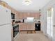Functional kitchen with laminate counters, white appliances and a window over the sink at 144 Wiley Dr, Douglasville, GA 30134
