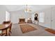 Spacious living room with a brick fireplace, ceiling fan, and two bright windows at 144 Wiley Dr, Douglasville, GA 30134