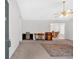 Neutral living room featuring ceiling fan, and a view of dining area with lots of light at 144 Wiley Dr, Douglasville, GA 30134