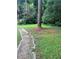 Backyard featuring a sidewalk, grassy areas, and trees at 1750 Beechwood Sw Blvd, Atlanta, GA 30311