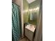 Bathroom featuring green walls, a leafy shower curtain, and a white vanity with a sink at 1750 Beechwood Sw Blvd, Atlanta, GA 30311