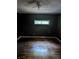 A dark bedroom featuring hardwood floors, a ceiling fan, and a single window at 1750 Beechwood Sw Blvd, Atlanta, GA 30311