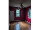 Bedroom with hardwood floors, barred windows, ceiling fan and a small closet at 1750 Beechwood Sw Blvd, Atlanta, GA 30311