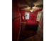 A cozy bedroom featuring red walls, barred windows, and a dark red carpet at 1750 Beechwood Sw Blvd, Atlanta, GA 30311