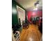 Bedroom featuring wood floors, red walls, and a window with blinds at 1750 Beechwood Sw Blvd, Atlanta, GA 30311