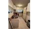 Kitchen featuring white cabinets, laminate countertops, and tile floors at 1750 Beechwood Sw Blvd, Atlanta, GA 30311