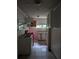 Bright kitchen featuring white cabinets, red stove, and a tiled floor layout at 1750 Beechwood Sw Blvd, Atlanta, GA 30311