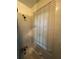 Shower featuring white tiled walls, silver fixtures, and a window with blinds at 1750 Beechwood Sw Blvd, Atlanta, GA 30311
