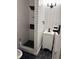 Modern bathroom featuring white subway tile, a black shower head, black accents, and hexagon tile at 2037 Brannen Se Rd, Atlanta, GA 30316