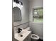 Bathroom featuring white subway tile, black accents, and a large window offering natural light at 2037 Brannen Se Rd, Atlanta, GA 30316