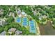 Aerial view showcases tennis courts, swimming pool, with waterfront views and beautiful surrounding landscape at 4115 Falls Ridge Dr, Johns Creek, GA 30022
