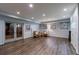 Spacious basement with wood flooring, recessed lighting, and glass doors at 4115 Falls Ridge Dr, Johns Creek, GA 30022