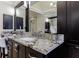 Bathroom featuring a white sink, dark cabinetry, marble countertops, and modern silver fixtures at 4115 Falls Ridge Dr, Johns Creek, GA 30022