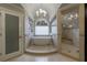 Spa-like bathroom featuring a soaking tub, walk-in shower, and elegant finishes at 4115 Falls Ridge Dr, Johns Creek, GA 30022