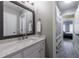 Bathroom featuring a marble vanity and mirror with a view of the hallway and bedroom at 4115 Falls Ridge Dr, Johns Creek, GA 30022