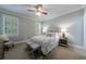 Cozy bedroom featuring neutral colors, a comfortable bed, and natural light at 4115 Falls Ridge Dr, Johns Creek, GA 30022