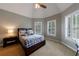 Cozy bedroom features a vaulted ceiling, neutral tones, and light-filled windows at 4115 Falls Ridge Dr, Johns Creek, GA 30022