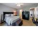 Bedroom featuring large bed with patterned linens, a ceiling fan, and a wardrobe at 4115 Falls Ridge Dr, Johns Creek, GA 30022