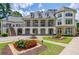 Elegant clubhouse featuring a two-story facade, manicured landscaping, and multiple windows for natural light at 4115 Falls Ridge Dr, Johns Creek, GA 30022