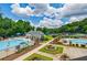 Aerial view of the community pool and recreational area with lush trees and inviting blue waters at 4115 Falls Ridge Dr, Johns Creek, GA 30022
