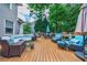Expansive wooden deck featuring ample seating, umbrellas, and lush greenery for relaxed outdoor living at 4115 Falls Ridge Dr, Johns Creek, GA 30022