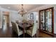 Formal dining room with a chandelier, seating for eight, and a large display case at 4115 Falls Ridge Dr, Johns Creek, GA 30022